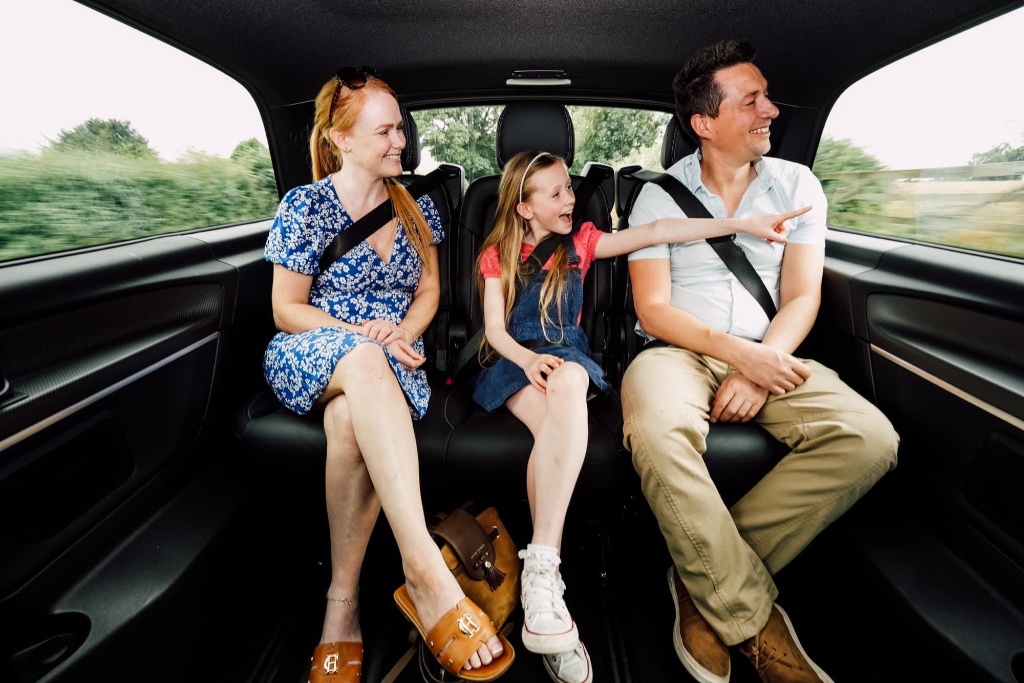 A family relaxing in the back of an Albatross Mercedes
