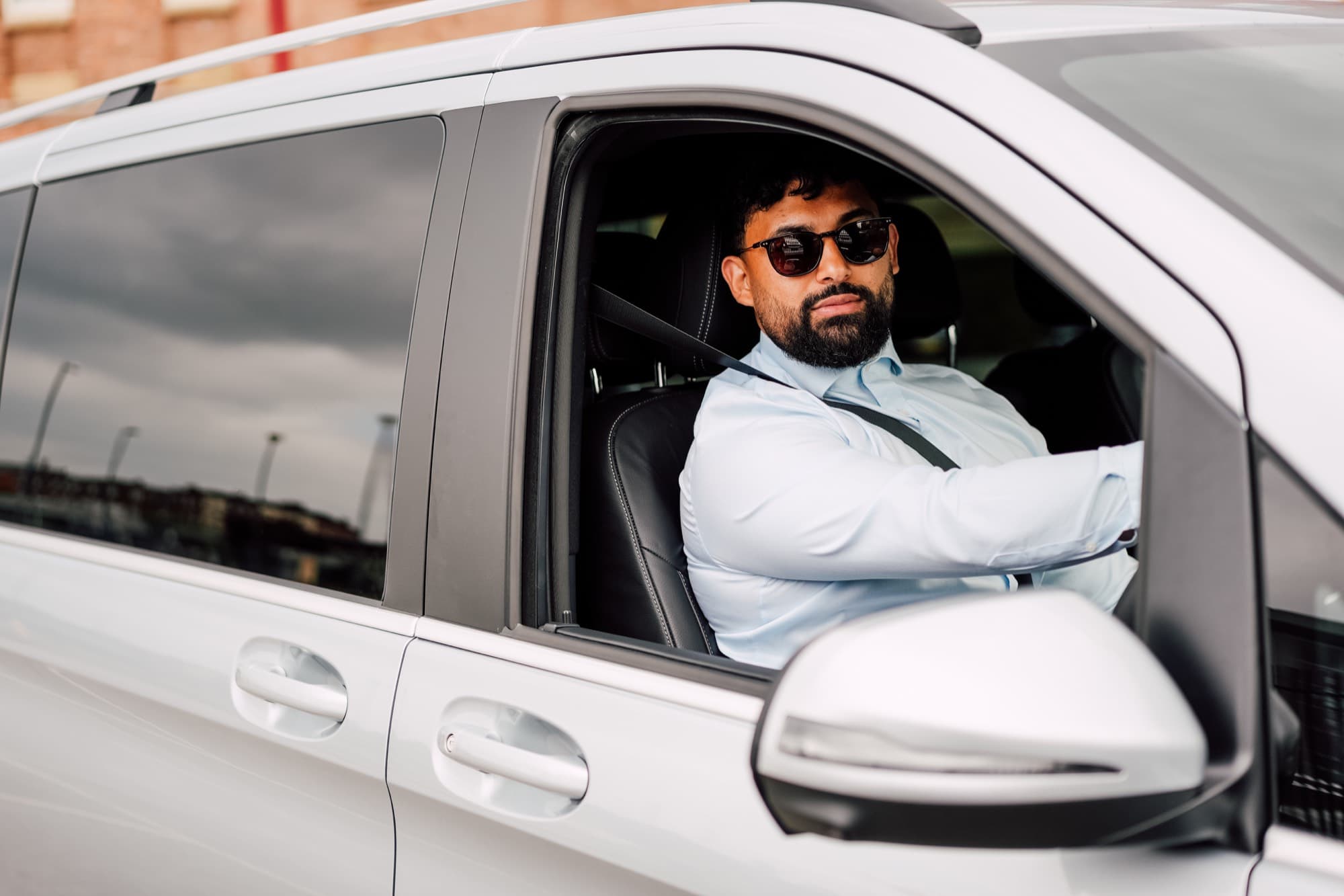 An Albatross chauffeur at the wheel of a Mercedes V-Class